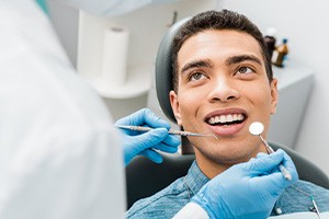 man smiling while visiting dentist